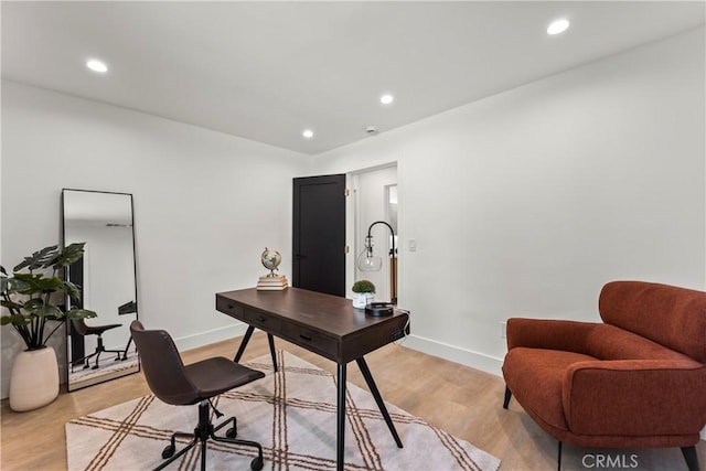office with light wood-type flooring, baseboards, and recessed lighting