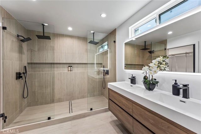 bathroom featuring a sink, double vanity, and a stall shower