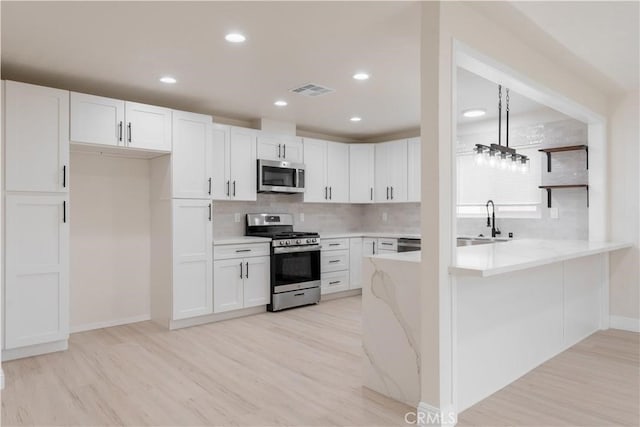 8672 La Grande St, Rancho Cucamonga, CA 91701 - kitchen with tasteful backsplash, appliances with stainless steel finishes, light wood finished floors, and a sink