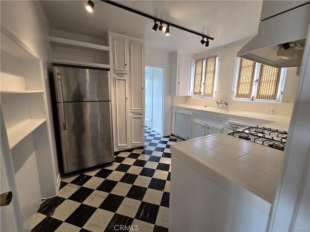 1958 Glencoe Way, Los Angeles, CA 90068 - kitchen with white dishwasher, tile counters, dark floors, range hood, and freestanding refrigerator