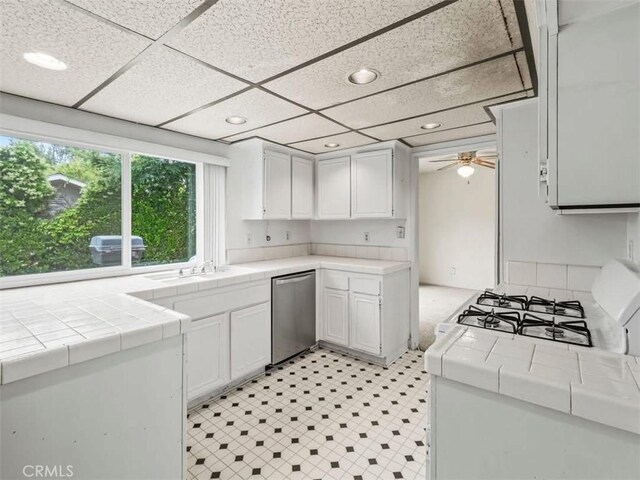 25582 Old Course Way, Valencia, CA 91355 - kitchen with dishwasher, tile counters, white cabinetry, recessed lighting, and a ceiling fan