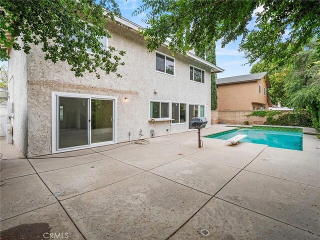 25582 Old Course Way, Valencia, CA 91355 - rear view of house featuring stucco siding, a patio area, and a fenced backyard