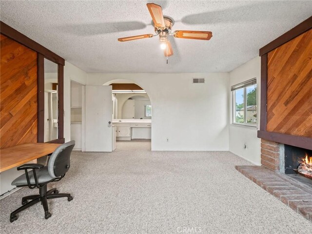 25582 Old Course Way, Valencia, CA 91355 - unfurnished office featuring carpet flooring, a textured ceiling, a fireplace, a ceiling fan, and arched walkways