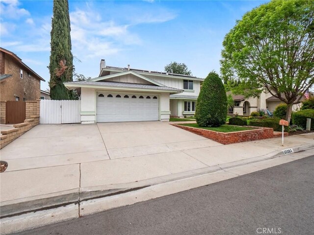 25582 Old Course Way, Valencia, CA 91355 - view of front of home with concrete driveway, an attached garage, a gate, and stucco siding