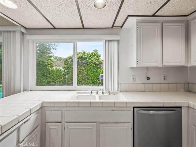 25582 Old Course Way, Valencia, CA 91355 - kitchen with stainless steel dishwasher, a paneled ceiling, and white cabinets