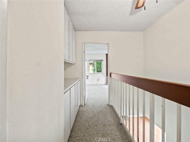25582 Old Course Way, Valencia, CA 91355 - corridor with light carpet and a textured ceiling