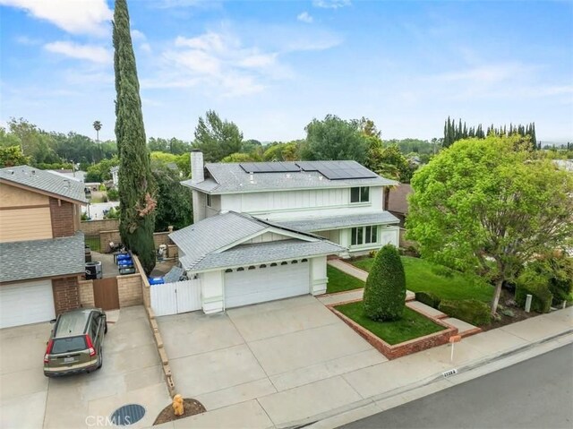 25582 Old Course Way, Valencia, CA 91355 - traditional-style home featuring a gate, solar panels, a garage, a chimney, and concrete driveway
