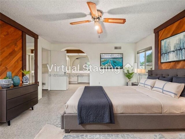 25582 Old Course Way, Valencia, CA 91355 - bedroom with a textured ceiling, carpet flooring, arched walkways, ceiling fan, and ensuite bathroom