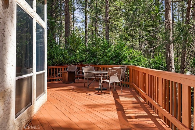deck with outdoor dining area