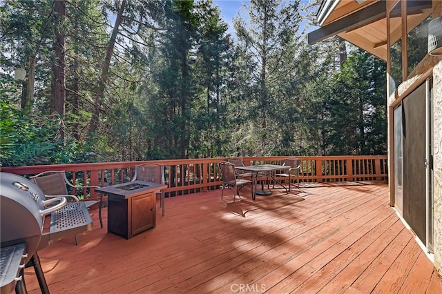 deck featuring outdoor dining area and area for grilling