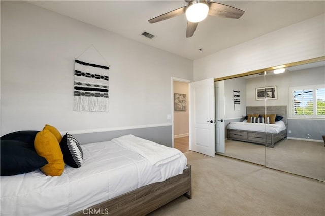 carpeted bedroom featuring visible vents, a closet, baseboards, and ceiling fan