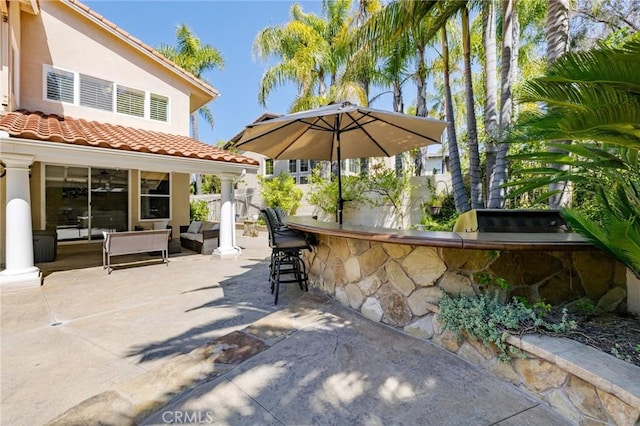 view of patio / terrace with an outdoor living space, outdoor dry bar, and fence