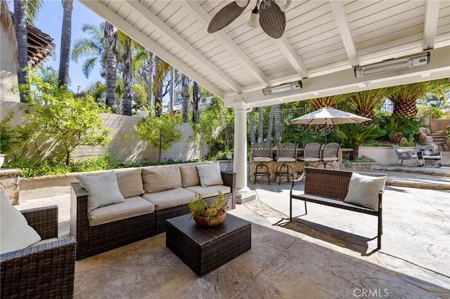 view of patio / terrace featuring an outdoor living space, a fenced backyard, and a ceiling fan