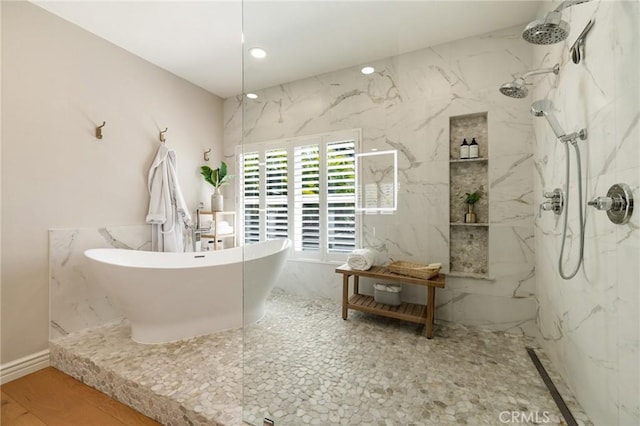 full bath with a marble finish shower, recessed lighting, a soaking tub, and wood finished floors