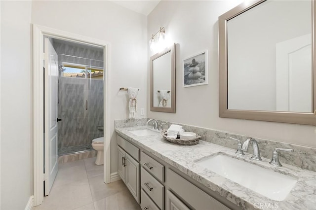 full bath featuring a shower stall, double vanity, a sink, and toilet