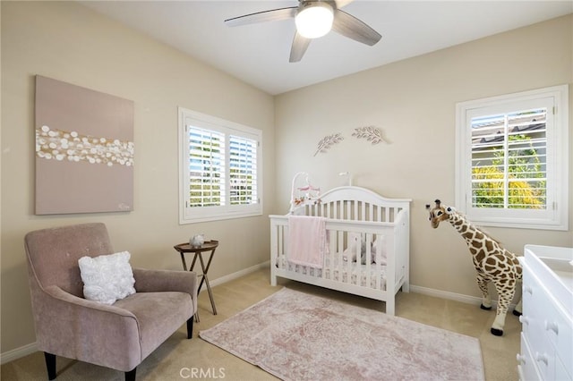 carpeted bedroom with baseboards, multiple windows, and ceiling fan