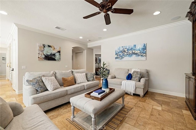 living area with visible vents, baseboards, arched walkways, a ceiling fan, and stone tile floors
