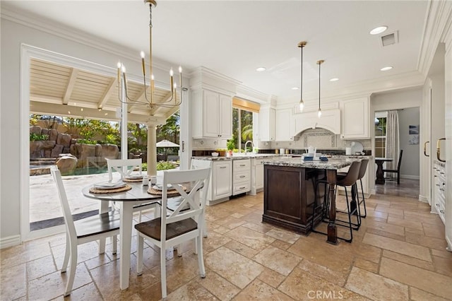 kitchen with stone tile floors, baseboards, and a kitchen island