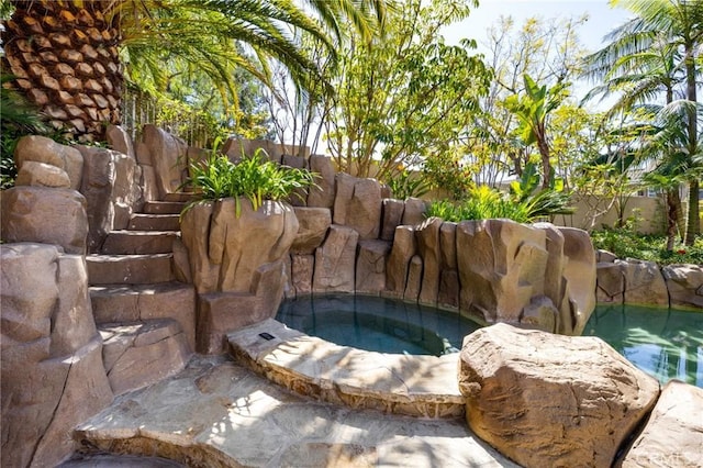 details featuring a jacuzzi and fence