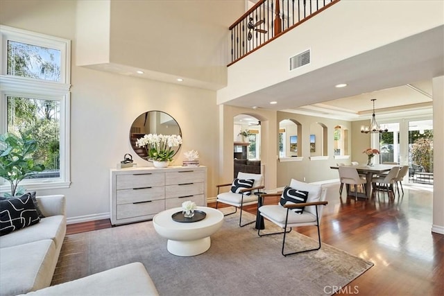4 Bastia, Laguna Niguel, CA 92677 - living area featuring visible vents, plenty of natural light, a notable chandelier, and dark wood-style floors