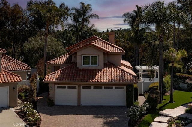 4 Bastia, Laguna Niguel, CA 92677 - view of front facade featuring a tile roof, driveway, a garage, and stucco siding