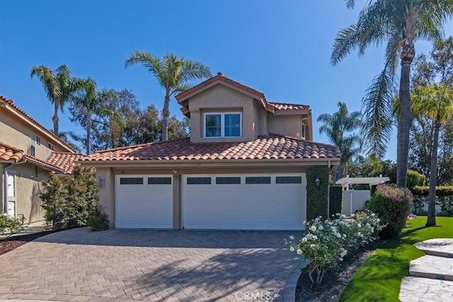 4 Bastia, Laguna Niguel, CA 92677 - mediterranean / spanish house featuring a tile roof, driveway, a garage, and stucco siding