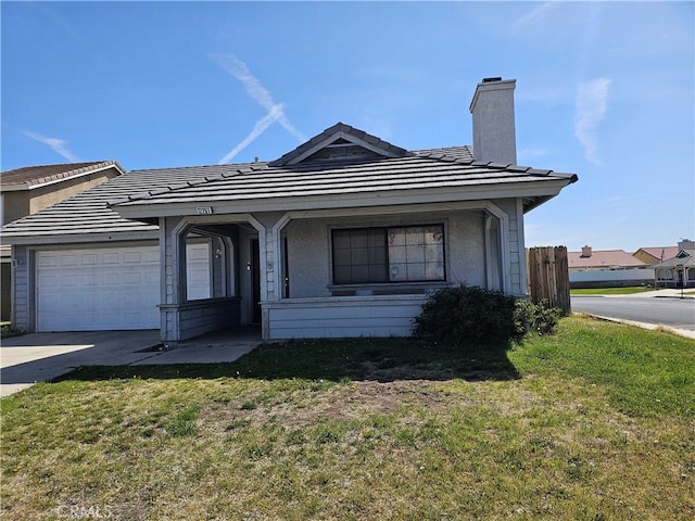 12261 Stonegate Cir, Victorville, CA 92392 - view of front facade with a chimney, an attached garage, concrete driveway, a tiled roof, and stucco siding
