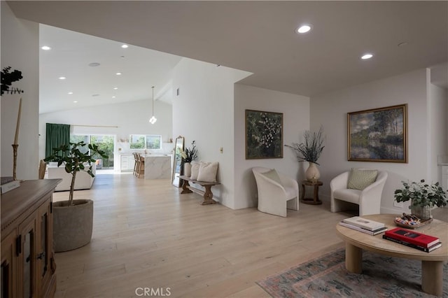 interior space with light wood-type flooring, recessed lighting, and high vaulted ceiling