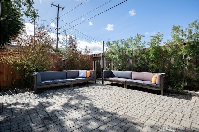 view of patio featuring an outdoor living space and a fenced backyard