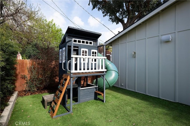 view of jungle gym with fence and a yard