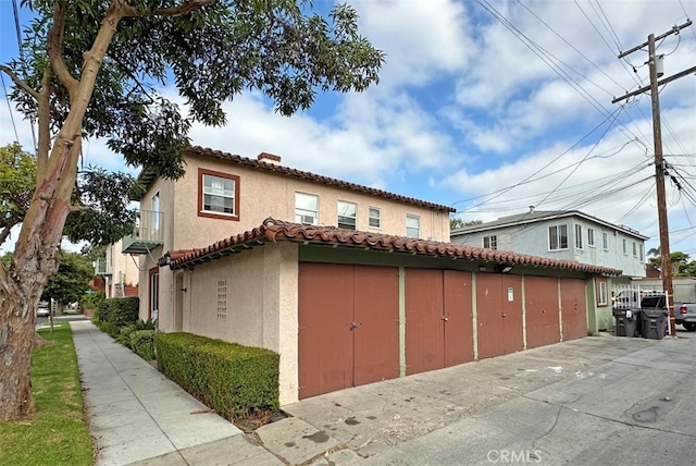 2200 Chestnut, Long Beach, CA 90806 - view of property exterior with stucco siding, a chimney, and a tiled roof