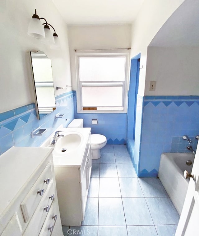 2200 Chestnut, Long Beach, CA 90806 - full bath with tile walls, vanity, tile patterned floors, a bath, and a wainscoted wall