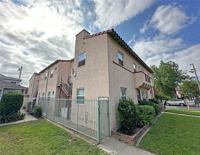 2200 Chestnut, Long Beach, CA 90806 - view of side of property featuring stucco siding and a tile roof