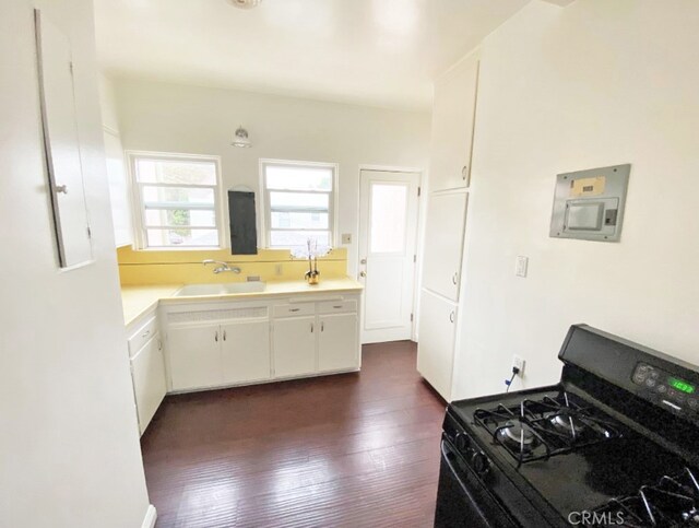 2200 Chestnut, Long Beach, CA 90806 - kitchen with black gas range oven, electric panel, dark wood-type flooring, light countertops, and white cabinetry