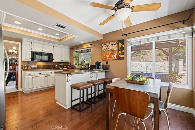 22004 Pamplico Dr, Saugus, CA 91350 - dining area with crown molding, a tray ceiling, visible vents, recessed lighting, and wood-type flooring