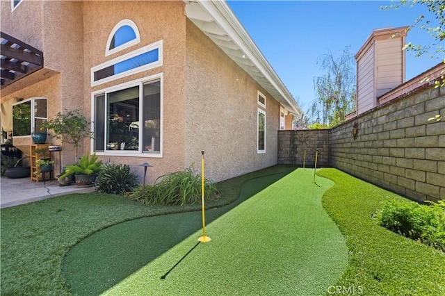 22004 Pamplico Dr, Saugus, CA 91350 - view of property exterior with a fenced backyard, stucco siding, and a patio area
