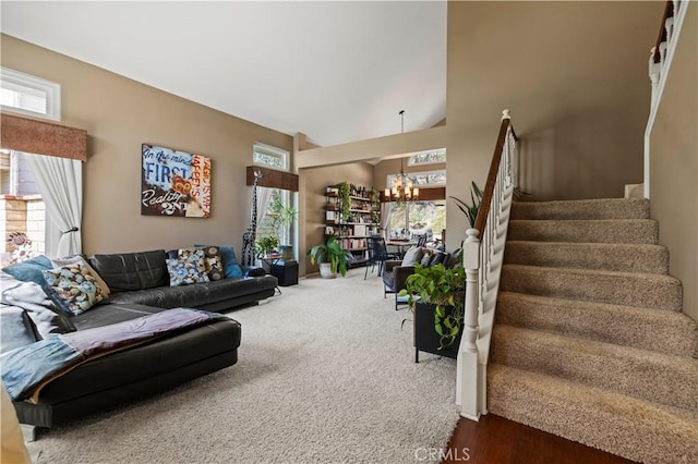 22004 Pamplico Dr, Saugus, CA 91350 - living room with stairway, a towering ceiling, an inviting chandelier, and dark carpet