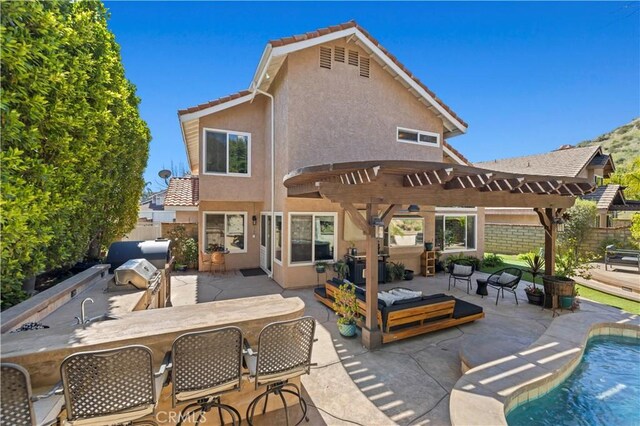 22004 Pamplico Dr, Saugus, CA 91350 - rear view of house featuring a tiled roof, exterior kitchen, a patio, and stucco siding