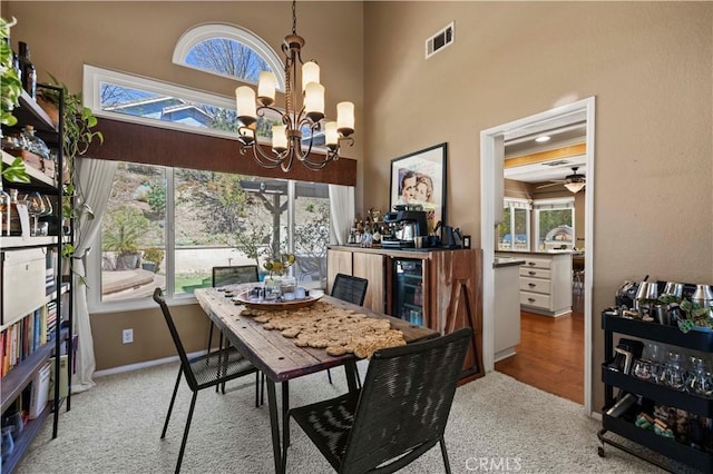 22004 Pamplico Dr, Saugus, CA 91350 - dining room with a towering ceiling, visible vents, beverage cooler, and ceiling fan with notable chandelier