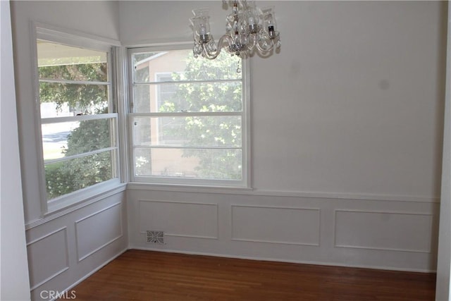 427 S Mariposa St, Burbank, CA 91506 - unfurnished dining area featuring a decorative wall, a chandelier, healthy amount of natural light, dark wood-type flooring, and a wainscoted wall