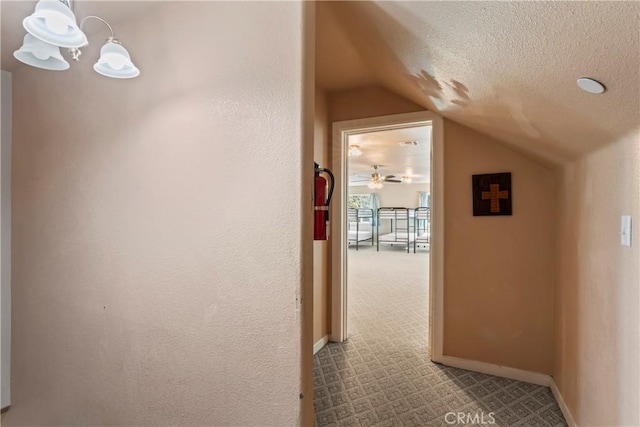 2745 Deer Creek Dr, Running Springs, CA 92382 - corridor with a chandelier, lofted ceiling, and a textured ceiling