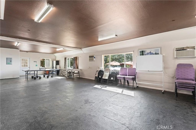 2745 Deer Creek Dr, Running Springs, CA 92382 - miscellaneous room featuring a wall unit AC, a textured ceiling, concrete floors, and electric panel