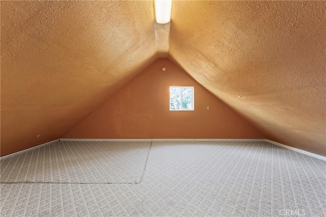 2745 Deer Creek Dr, Running Springs, CA 92382 - additional living space featuring carpet floors, a textured ceiling, and lofted ceiling