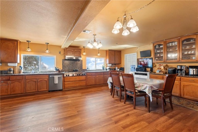 2745 Deer Creek Dr, Running Springs, CA 92382 - kitchen featuring appliances with stainless steel finishes, a chandelier, brown cabinets, plenty of natural light, and beamed ceiling