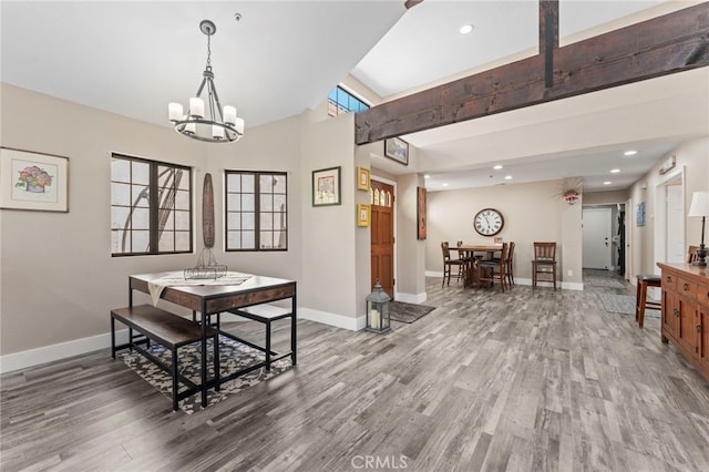 dining space with baseboards, recessed lighting, wood finished floors, and a chandelier