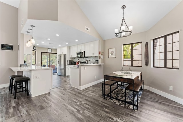 dining area featuring visible vents, dark wood-style flooring, baseboards, recessed lighting, and a chandelier