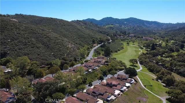 birds eye view of property with a residential view, a mountain view, and view of golf course