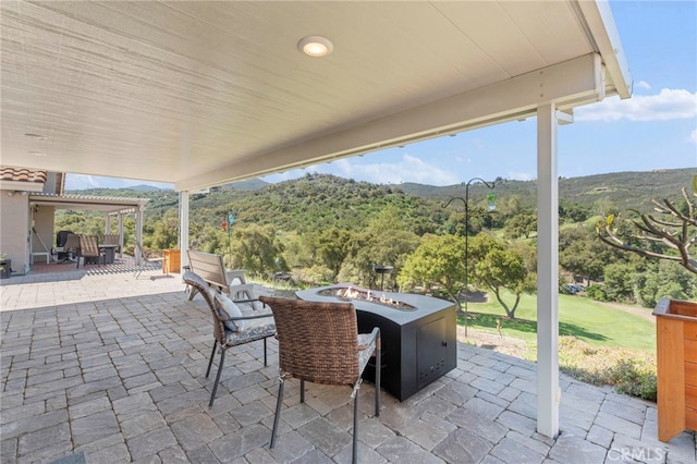 view of patio featuring a mountain view and an outdoor fire pit