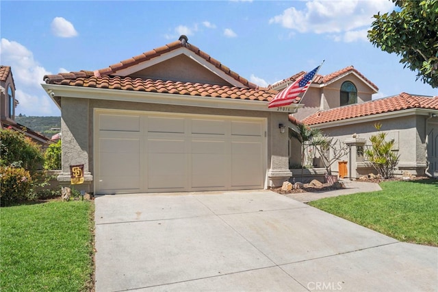 mediterranean / spanish home with concrete driveway, stucco siding, a front yard, and a garage