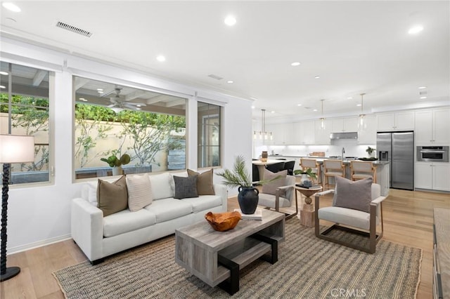 42 Cipresso, Irvine, CA 92618 - living room featuring light wood-type flooring, ceiling fan, recessed lighting, and baseboards